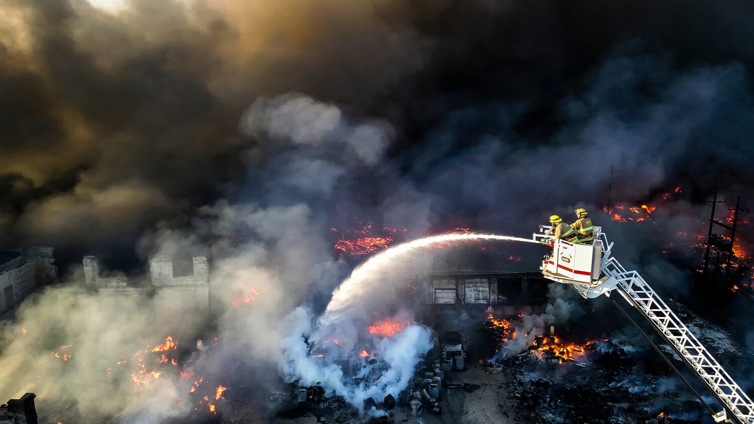 Crews from multiple departments work to extinguish a fire at an industrial facility Tuesday, April 11, 2023 in Richmond, Indiana. The 14-acre site was used to store various kinds of plastic for recycling and resale. People who lived within a half-mile of the plant were told to evacuate and a large column of black smoke could be seen for miles. NICK GRAHAM/JOURNAL-NEWS